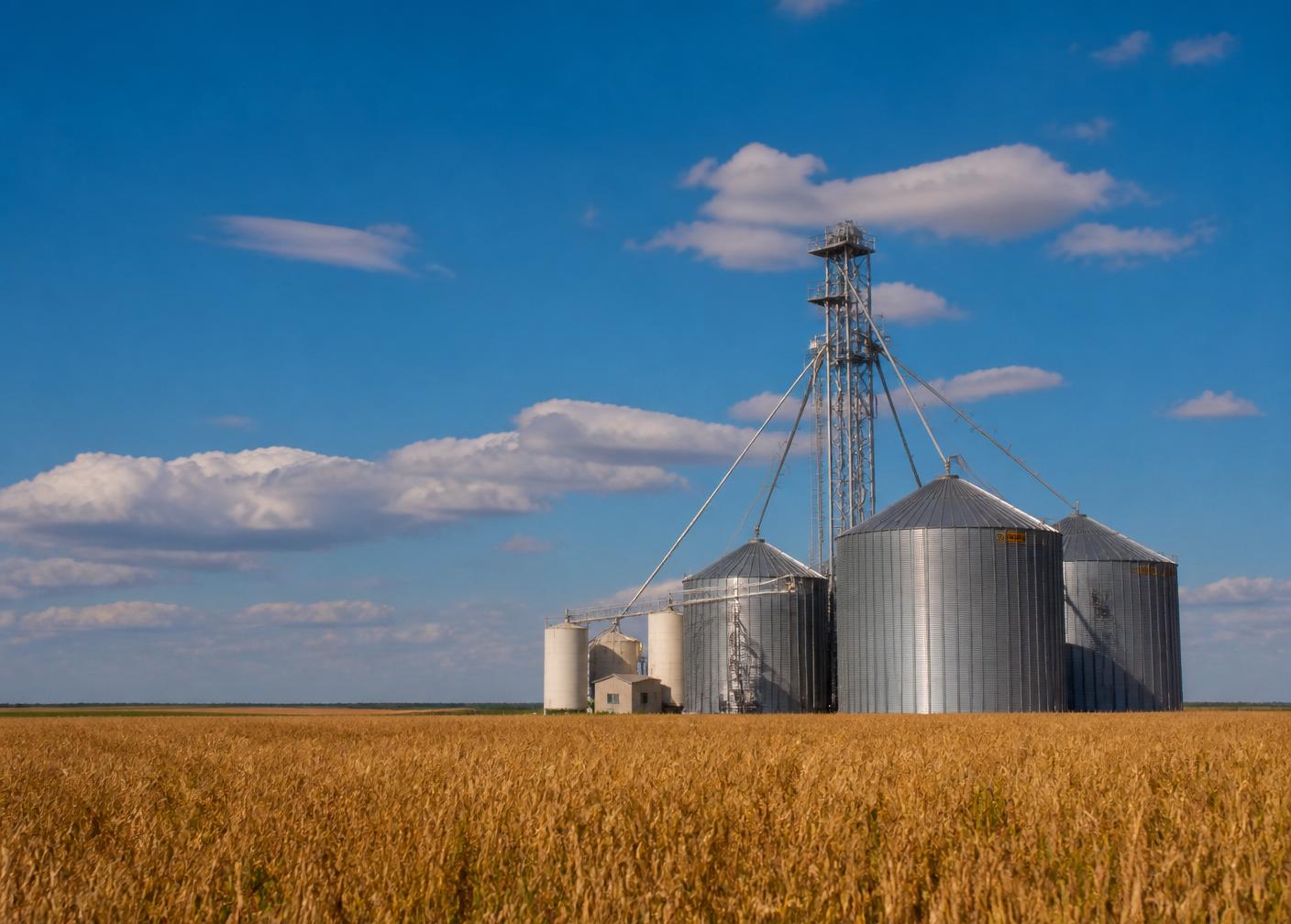 Grain elevator and silos over Oklahoma farmland